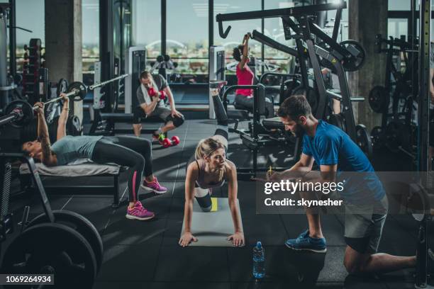 group of athletic people exercising in a health club. - personal training stock pictures, royalty-free photos & images