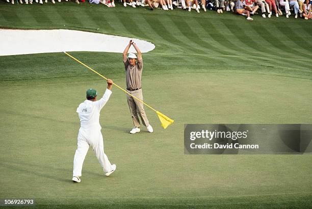 Sandy Lyle of Scotland holes out his winning putt on the 18th green during the final round of the U.S Masters GolfTournament on 10th April 1988 at...