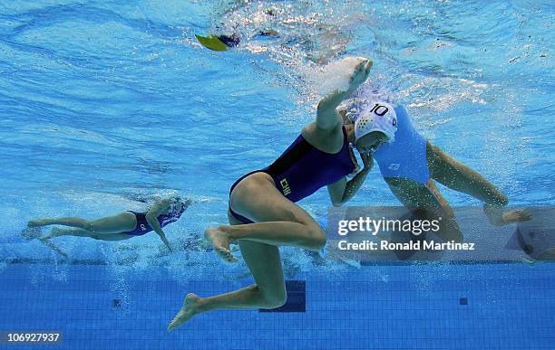 Huanhuan Ma of China struggles with Anna Zubkova of Kazakhstan in the Women's Water Polo during day five of the 16th Asian Games Guangzhou 2010 at...