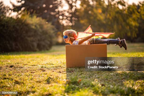 side view little cute boy imagine to fly - box kite stock pictures, royalty-free photos & images