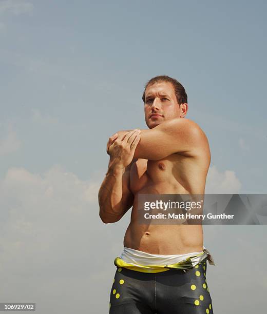 male athlete stretching before workout - male stomach stock-fotos und bilder