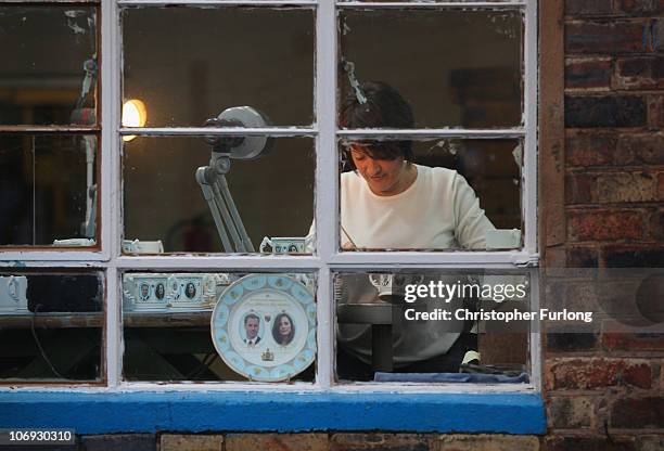 Worker Claire Wright gilds a loving mug at Aynsley China as the company start producing commemorative plates, cups and mugs to mark the engagement...