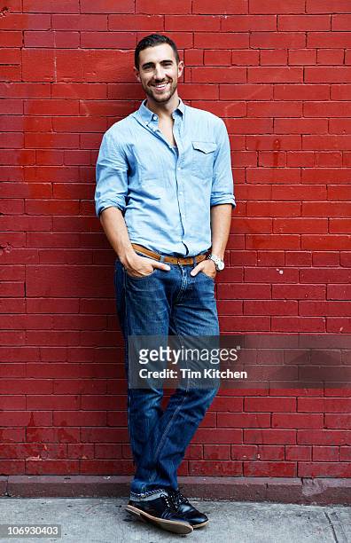 man standing next to brick wall, portrait - luta fysisk ställning bildbanksfoton och bilder