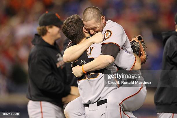 Buster Posey hugs Aubrey Huff of the San Francisco Giants celebrate their 3-1 victory to win the World Series over the Texas Rangers in Game Five of...