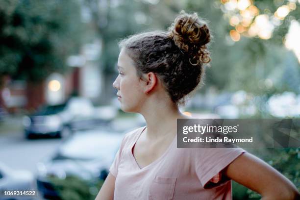 profile of a teenage girl - hair bun stock pictures, royalty-free photos & images