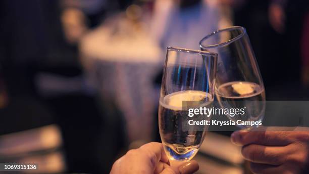 couple toasting with champagne at party - champagne toast stock-fotos und bilder