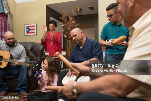 family and friends dancing and playing musical instruments - puerto rican ethnicity stock pictures, royalty-free photos & images
