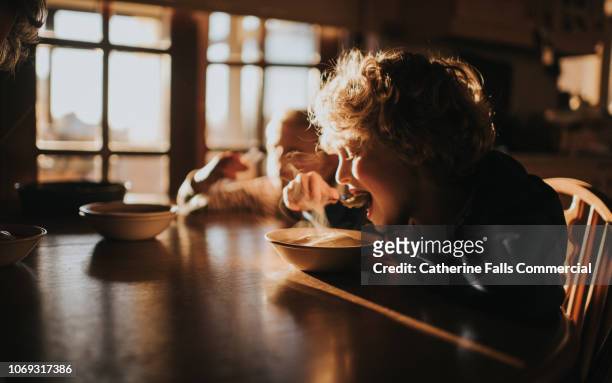 little boy eating pudding - soup stock pictures, royalty-free photos & images