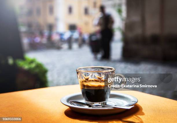cup of hot black coffee espresso on table in street cafe - espresso fotografías e imágenes de stock