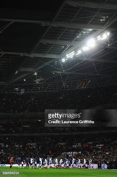 The England and France teams lead out prior to the international friendly match between England and France at Wembley Stadium on November 17, 2010 in...