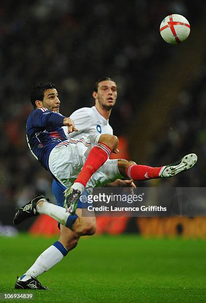 Adil Rami of France clears the ball ahead of Andy Carroll of England during the international friendly match between England and France at Wembley...