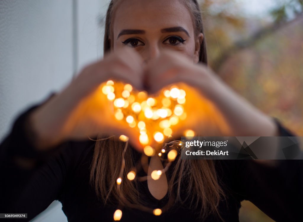 Young woman with magic lights