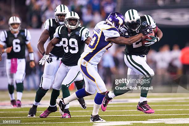 LaDainian Tomlinson of the New York Jets rushes as Madieu Williams of the Minnesota Vikings defends on October 11, 2010 at the New Meadowlands...