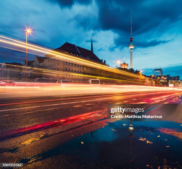 modern berlin urban night skyline with traffic and city reflection - city traffic stock-fotos und bilder