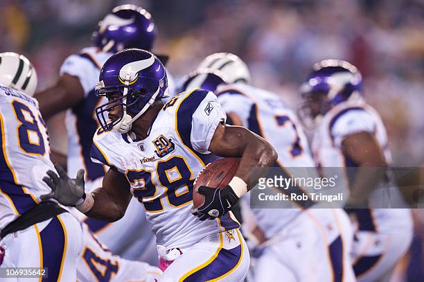 Adrian Peterson of the Minnesota Vikings rushes against the New York Jets on October 11, 2010 at the New Meadowlands Stadium in East Rutherford, New...