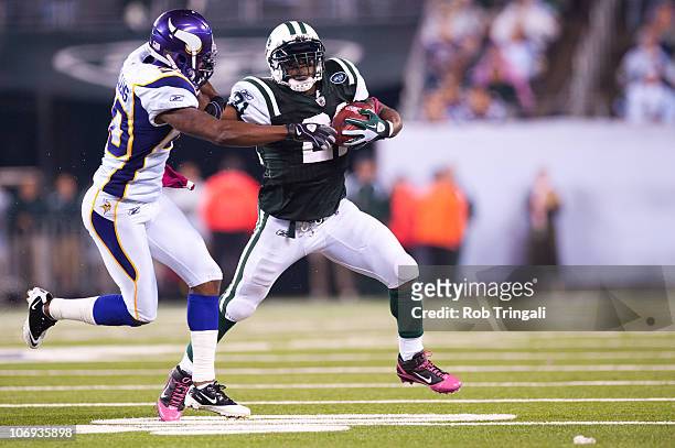 LaDainian Tomlinson of the New York Jets rushes against Madieu Williams and the Minnesota Vikings on October 11, 2010 at the New Meadowlands Stadium...
