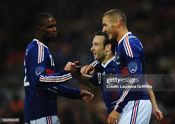 Mathieu Valbuena of France celebrates with Eric Abidal and Karim Benzema as he scores their second goal during the international friendly match...