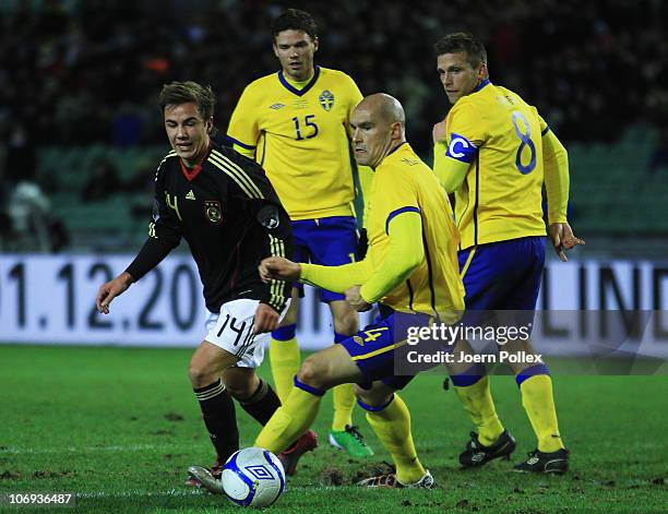 Mario Goetze of Germany and Daniel Majstorovic of Sweden battle for the ball during the international friendly match between Sweden and Germany at...