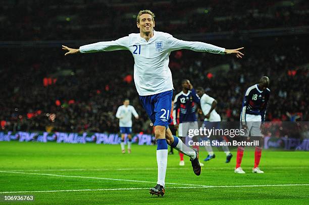 Peter Crouch of England celebrates as he scores their first goal during the international friendly match between England and France at Wembley...