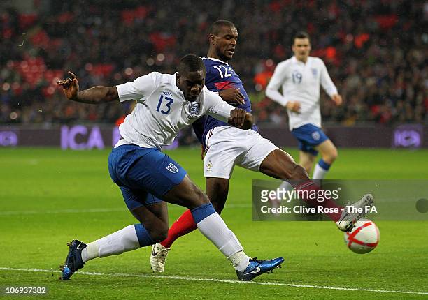Micah Richards of England battles for the ball with Anthony Reveillere of France during the international friendly match between England and France...