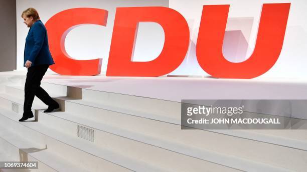 German Chancellor and leader of the Christian Democratic Union Angela Merkel leaves the stage in front of a huge CDU logo after her speech at a party...