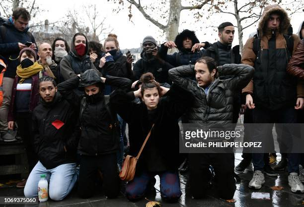 High school students re-enact yesterday's student arrest in Mantes-la-Jolie during a demonstration at the place de la Republique in Paris, on...