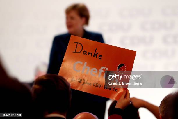 Party member holds up a sign reading 'Thank you chief' as Angela Merkel, Germany's chancellor and Christian Democrat Union leader, delivers her...