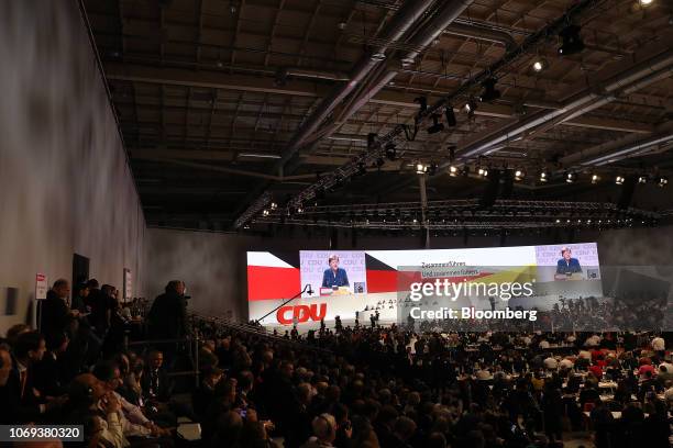 Angela Merkel, Germany's chancellor and Christian Democrat Union leader, is displayed on screens as she delivers her speech at the CDU party...