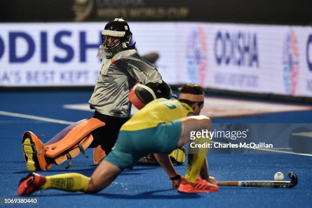 Dylan Wotherspoon of Australia scores his team's 9th goal as Caiyu Wang of China looks on during the FIH Men's Hockey World Cup Group B match between...