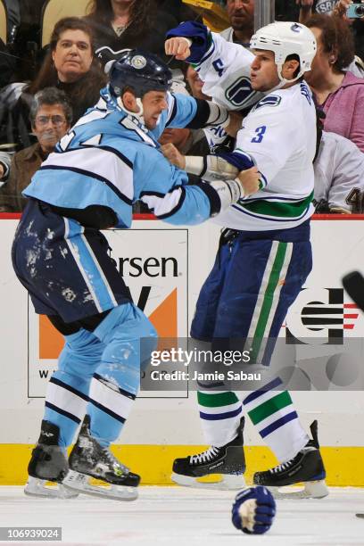 Craig Adams of the Pittsburgh Penguins and Kevin Bieksa of the Vancouver Canucks exchange blows during a first period fight on November 17, 2010 at...