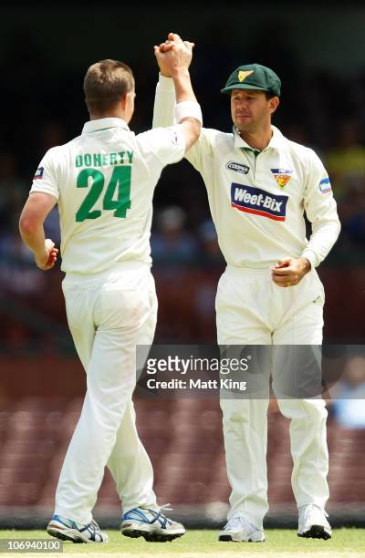 Ricky Ponting of the Tigers celebrates with bowler Xavier Doherty after taking a catch to dismiss Moises Henriques of the Blues during day two of the...
