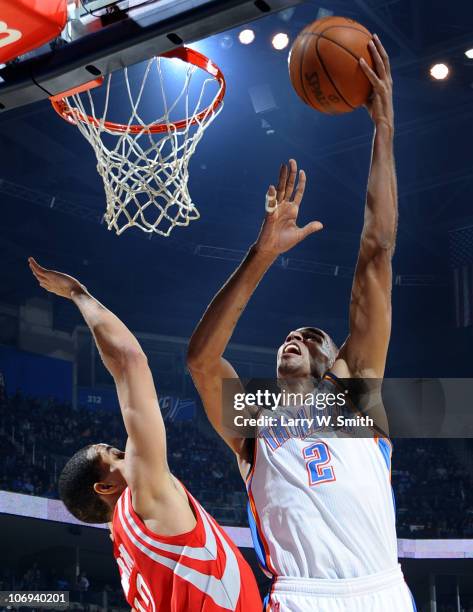 Thabo Sefolosha of the Oklahoma City Thunder goes to the basket against Kevin Martin of the Houston Rockets during the game at the Oklahoma City...