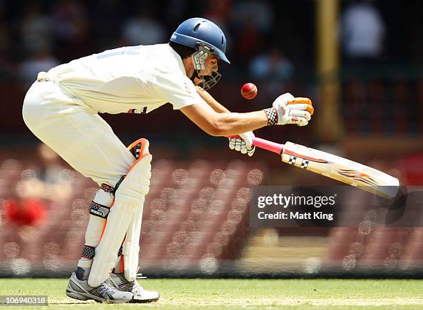 Moises Henriques of the Blues is hit by James Faulkner of the Tigers during day two of the Sheffield Shield match between the New South Wales Blues...