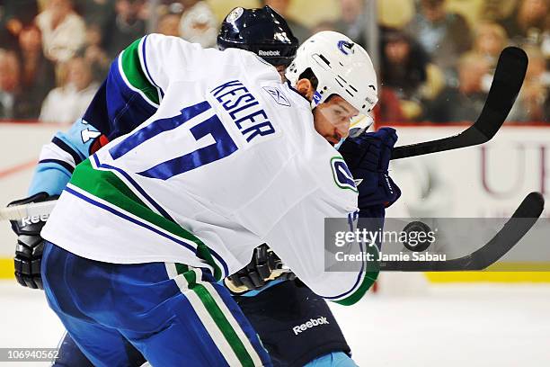 Ryan Kesler of the Vancouver Canucks takes a face off against Sidney Crosby of the Pittsburgh Penguins on November 17, 2010 at Consol Energy Center...