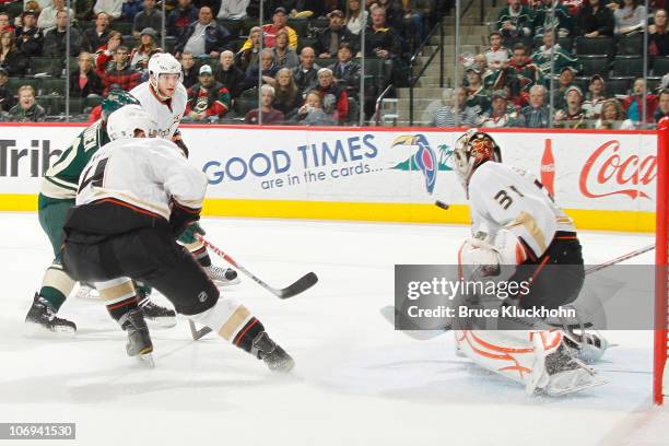 Antti Miettinen of the Minnesota Wild scores the game-winning goal in overtime against Jonas Hiller and the Anaheim Ducks during the game at the Xcel...