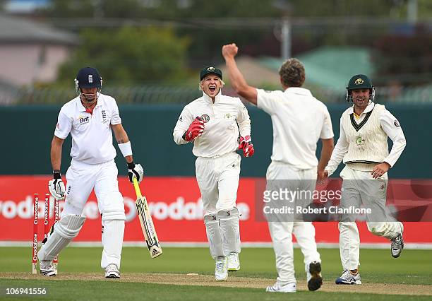 Steve O'Keefe of Australia celebrates with Tim Paine and Ed Cowan after he bowled out Kevin Pietersen of England during day two of the Tour Match...