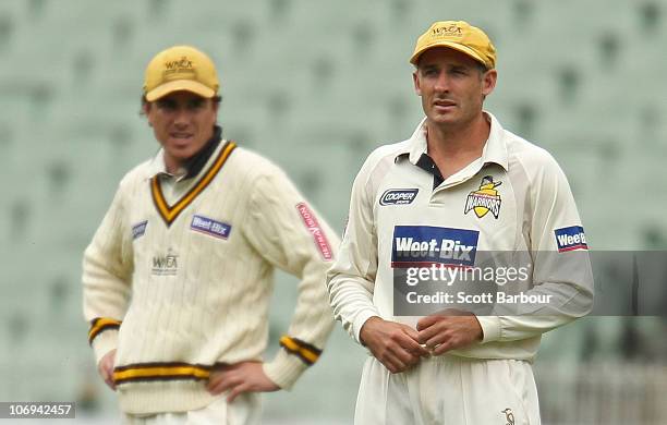 Marcus North and Michael Hussey of the Warriors look on while fielding during day two of the Sheffield Shield match between the Victorian Bushrangers...