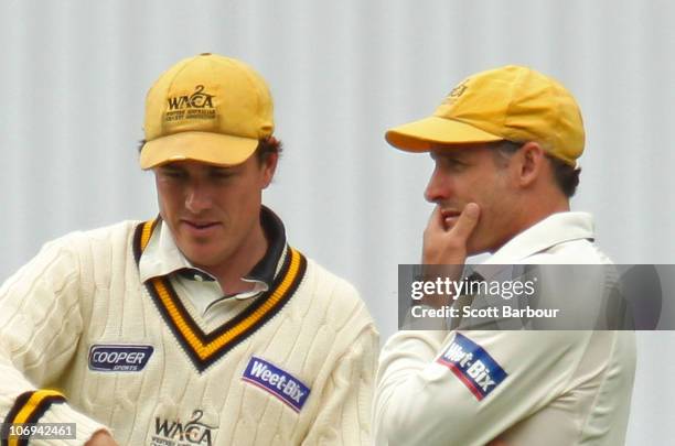 Marcus North and Michael Hussey of the Warriors look on while fielding during day two of the Sheffield Shield match between the Victorian Bushrangers...