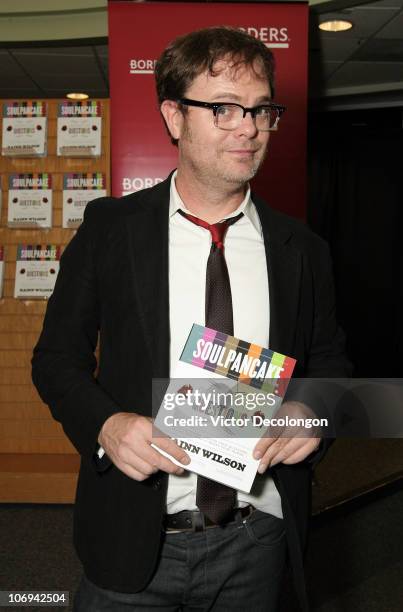 Actor Rainn Wilson poses for a photo holding his book 'SoulPancake' after a book signing on November 17, 2010 in Los Angeles, California.