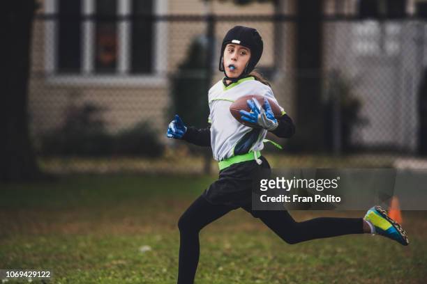 A girl playing flag football.