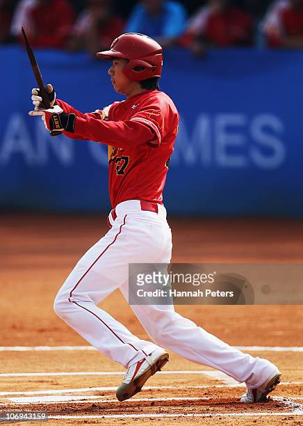 Xiao Cui of China breaks his bat during the baseball match between Korea and China during day six of the 16th Asian Games Guangzhou 2010 at Aoti...
