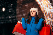 Tired Girl Holding Shopping Bags on Christmas Lights Décor