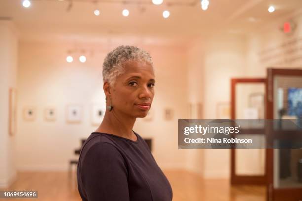 a woman embracing her age with a carefree natural hairstyle. - philanthrop stock-fotos und bilder