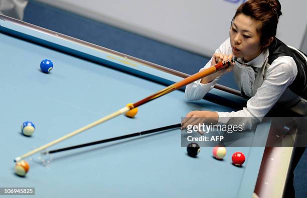 Kim Ga-Young of South Korea competes during the women's 8-ball pool singles final at the 16th Asian Games in Guangzhou on November 18, 2010. Kim won...