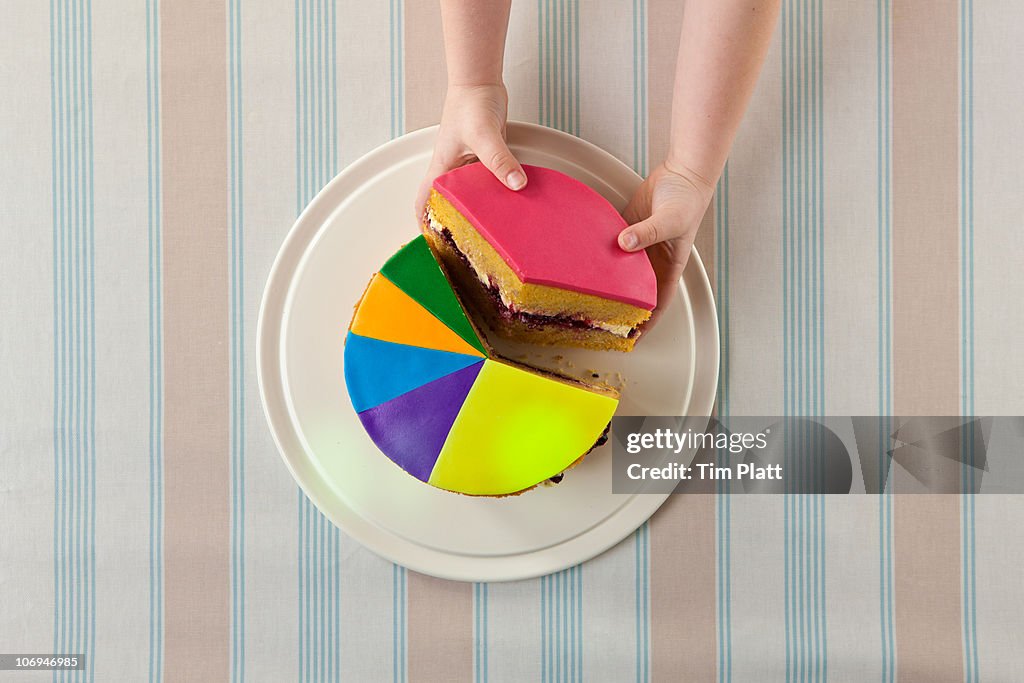 A child takes slice of a 'pie chart' cake.