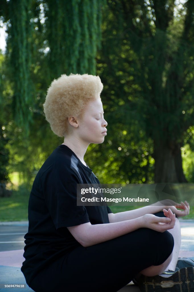 Woman with natural hair meditating