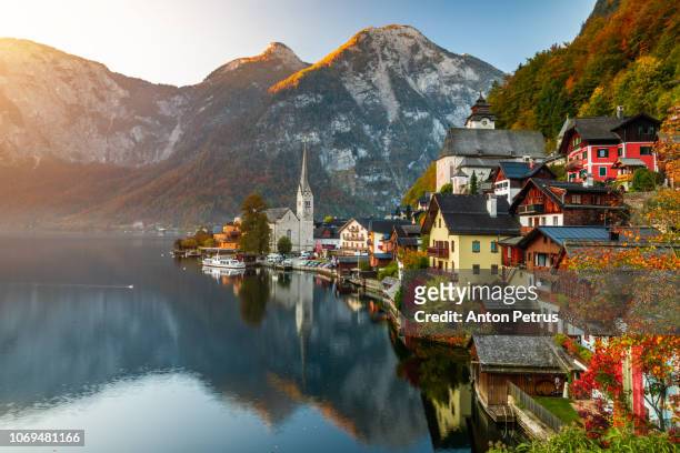 sunrise view of famous hallstatt mountain village with hallstatter lake, austria - austria stock pictures, royalty-free photos & images