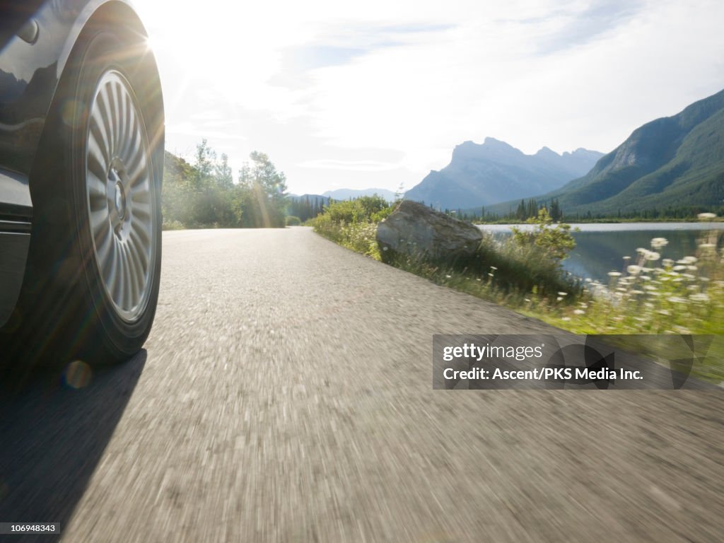 Detail of car tire spinning on mountain road