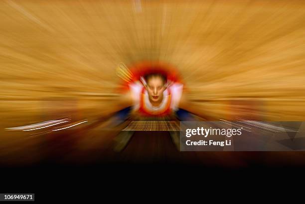 Cao Lei of China competes in the weightlifting Women's 75 kg Group A during day six of the 16th Asian Games Guangzhou 2010 at Dongguan Gymnasium on...