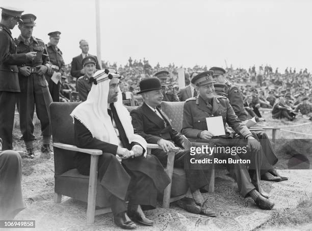 King Abdullah I of Transjordan watches military manoeuvres on Salisbury Plain, 23rd August 1949. The School of Infantry at Warminster have organised...